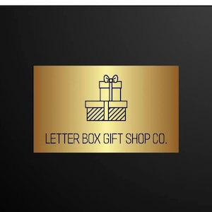 May include: A gold rectangular sign with the text "LETTER BOX GIFT SHOP CO." and a graphic of two stacked gift boxes with bows. The background is black.