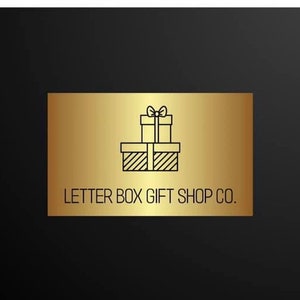 May include: A gold rectangular sign with the text "LETTER BOX GIFT SHOP CO." and a graphic of two stacked gift boxes with bows. The background is black.