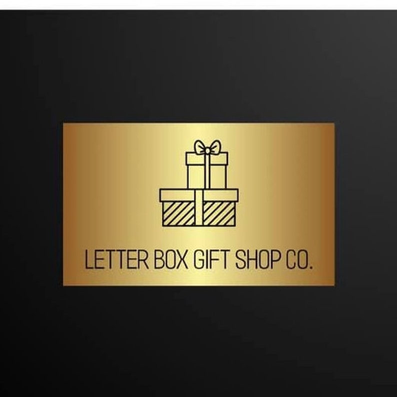 May include: A gold rectangular sign with the text "LETTER BOX GIFT SHOP CO." and a graphic of two stacked gift boxes with bows. The background is black.