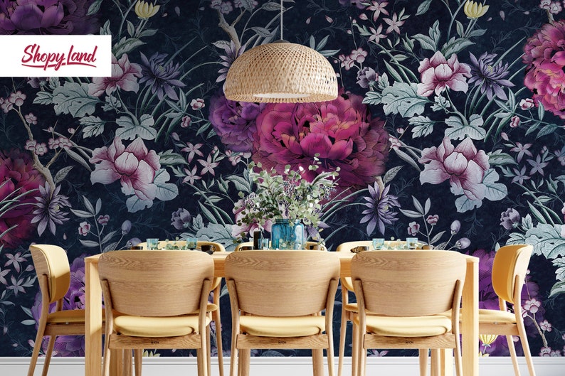 May include: A dining room with a dark blue floral wallpaper featuring pink and purple flowers. A woven pendant light hangs above a wooden table with six chairs.