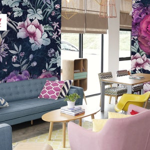 May include: A living room interior design with a blue sofa, pink armchair, and a wooden coffee table. The walls are decorated with a floral wallpaper featuring pink and purple flowers on a dark blue background. The text "Shoppy Land" is visible on the wall.