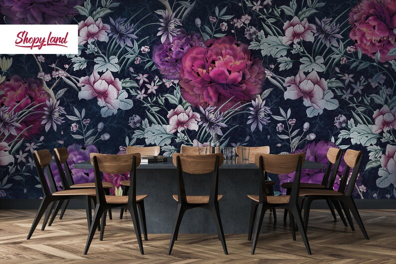 May include: A dining room with a dark blue floral wallpaper featuring pink and purple flowers. A dark gray table with six wooden chairs is in the center of the room.