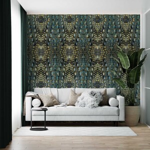 May include: A white sofa with pillows in a living room with a green plant and a wall covered in a crocodile skin pattern wallpaper.