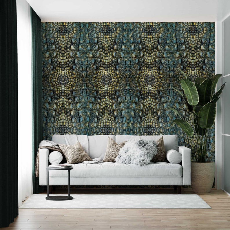 May include: A white sofa with pillows in a living room with a green plant and a wall covered in a crocodile skin pattern wallpaper.