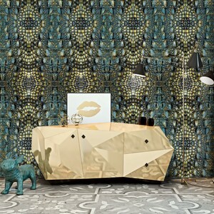 May include: A gold geometric console table with a mirrored finish sits in front of a wall covered in teal and gold crocodile skin patterned wallpaper. A teal blue ceramic dog figurine sits on the floor in front of the table.