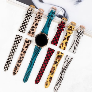 May include: Assortment of colorful patterned watch bands with gold clasps. The bands feature various animal prints, checkered patterns, and stripes.