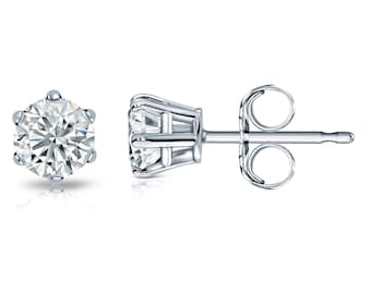 May include: A pair of silver stud earrings with a round, clear gemstone in the center of each earring.