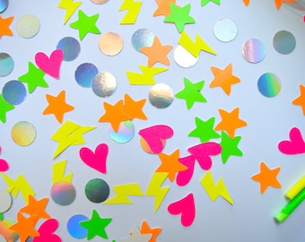 May include: A white background with neon pink, green, orange, and yellow hearts, stars, and lightning bolts.