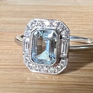 Aquamarine and diamond halo dress ring