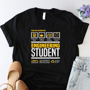 May include: Black t-shirt with a white graphic that says "Engineering Student" and includes icons for math, coffee, multitasking, and time management. The graphic also includes the text "100% Authentic" and a warning symbol.