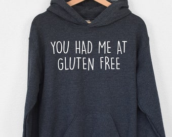 May include: A dark gray hooded sweatshirt with the text "You had me at gluten free" printed in white on the front.