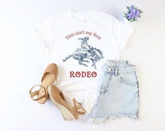 Camiseta "Esta no es mi primera rodeo", camiseta vaquera, camiseta del oeste, camiseta de rodeo para mujer, camiseta campestre, camiseta de rodeo texano, camiseta de música country