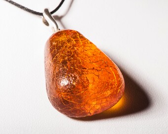 Pendant made of natural amber A piece of bread with a crust.