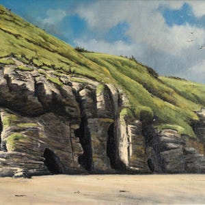 May include: Oil painting of a coastal landscape featuring a sandy beach, rugged cliffs, and a grassy hillside under a cloudy sky. The cliffs are a mix of gray and tan, with patches of green vegetation. Birds fly in the sky.