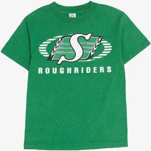 May include: Green t-shirt with a white and black logo that says "S" inside an oval with the text "ROUGHRIDERS" below. The shirt is short-sleeved and made of a soft material.