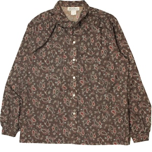May include: Brown long-sleeve button-down shirt with a paisley pattern in red, white, and tan. The shirt has a collared neckline and buttoned cuffs. The tag reads "Lady Manor".