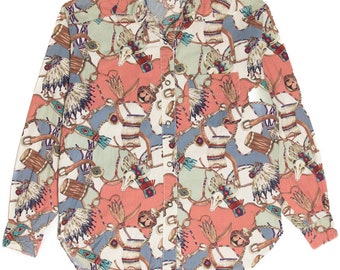 May include: A long-sleeved button-up shirt with a white background and a colorful print of Native American headdresses, drums, and other traditional designs. The shirt has a collar and a pocket on the left side. The brand name "BANJO" is visible on the label.