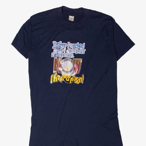 May include: Navy blue t-shirt with a graphic design. The design includes the text "Before I worked, I drank for no reason. NOW (I have a reason!)" in various colors. The shirt is made of a soft material.