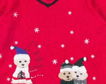 May include: Red Christmas sweater with a V-neck and black trim. The sweater features embroidered images of dogs wearing Santa hats and sweaters, along with snowflakes and a Christmas tree. The brand name "Crazy Horse" is visible on the tag.