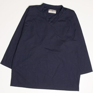 May include: A navy blue long-sleeved shirt with a v-neck. The shirt has a small tag on the front that says "Superdry".