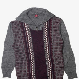 May include: A gray and burgundy patterned sweater with a zippered collar.