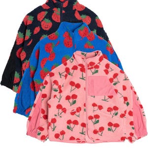 May include: Three fleece jackets with a full-zip closure and a stand-up collar. The jackets are patterned with red strawberries on a black, blue, and pink background.