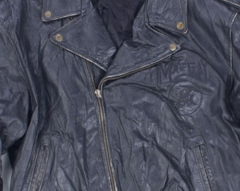 May include: A vintage black leather jacket with a zipper closure, lapel collar, and two front pockets. The jacket has a worn, textured appearance and features a logo on the chest. The jacket has a length of approximately 25 inches.