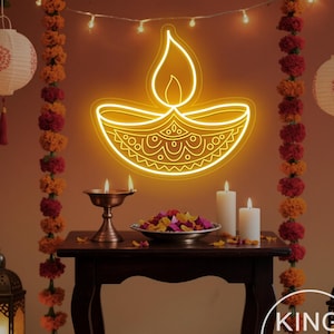 May include: A vibrant scene with a yellow neon diya sign, representing light and hope. The setting includes candles, lanterns, and floral decorations, creating a celebratory ambiance. The image is from King Neon.