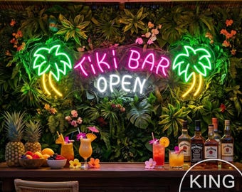 May include: A neon sign displaying the text Tiki Bar OPEN in pink and white, flanked by two yellow palm tree icons. The sign is mounted on a lush green wall of tropical foliage, positioned above a wooden bar with carved tiki-style pillars.