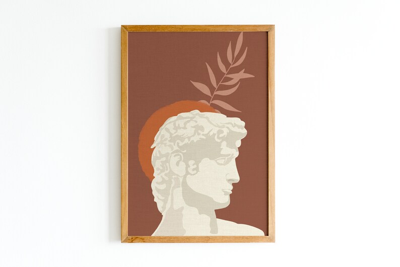 Pu&ograve; includere: Una stampa incorniciata con un design minimalista che presenta una scultura bianca della testa di un uomo su uno sfondo marrone e una foglia rosa.