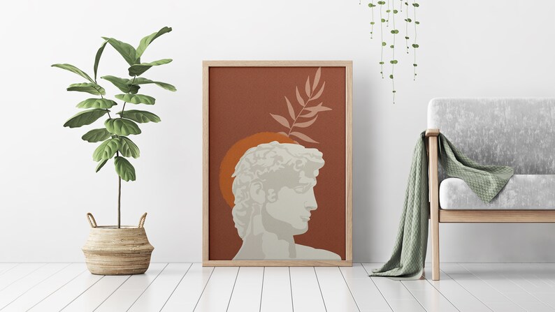 Pu&ograve; includere: Una stampa d'arte digitale che presenta una silhouette bianca di una testa di scultura classica su uno sfondo marrone con un ramo di foglie verdi. La scultura &egrave; circondata da un cerchio arancione.