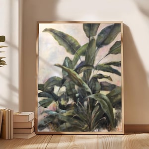 May include: A painting of a large green plant with large leaves in a light brown frame. The background is a light beige colour with hints of pink and blue.