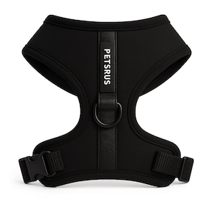 May include: Black dog harness with the text "PETSRUS" on a vertical strap. The harness has a D-ring for leash attachment and adjustable straps with a buckle closure. The harness is made of a soft, flexible material.