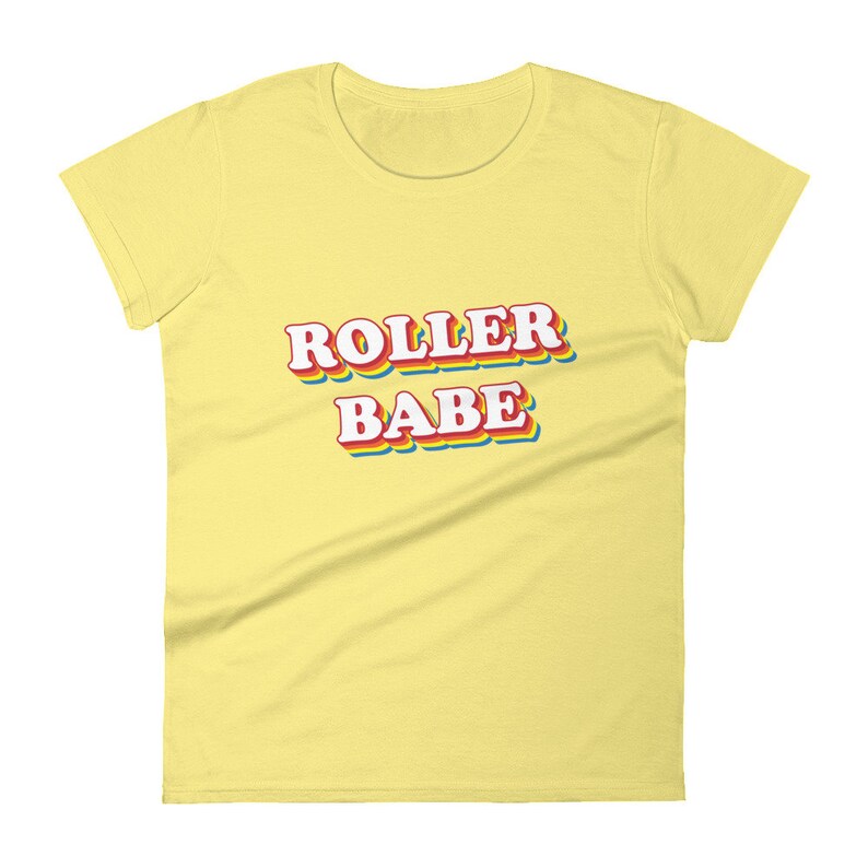 May include: A yellow women's t-shirt with the text "ROLLER BABE" in rainbow-colored letters.