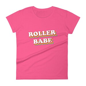 May include: Pink women's t-shirt with the text "ROLLER BABE" in rainbow letters.