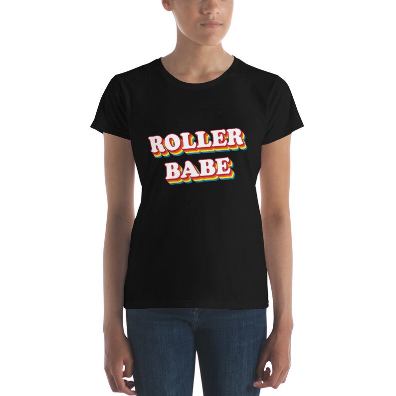 May include: Black short-sleeved t-shirt with the text "ROLLER BABE" in rainbow-colored letters.