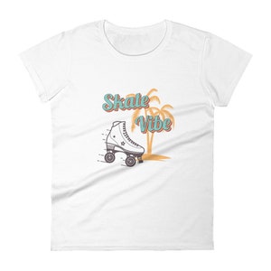 May include: White t-shirt with a graphic of a roller skate, palm trees, and the text "Skate Vibe" in teal and orange.