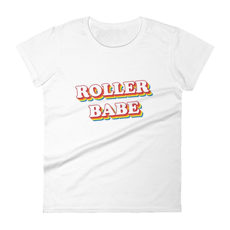 May include: White women's t-shirt with the text "ROLLER BABE" in rainbow colors.