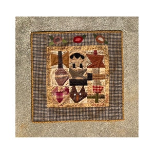 May include: A patchwork quilt with a brown, tan, and red color scheme. The quilt features a variety of shapes and designs, including a cat, a house, and a star. The quilt is surrounded by a brown and tan border.