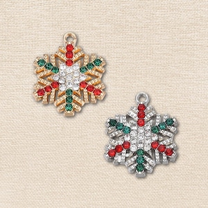 May include: Two snowflake-shaped metal charms featuring a central cluster of clear rhinestones surrounded by alternating arms inlaid with red and green crystals. Each charm includes a small circular loop at the top for attachment purposes.