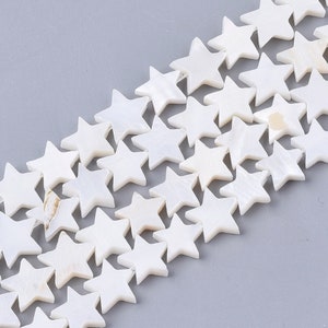 May include: A strand of white star-shaped beads made from mother of pearl.