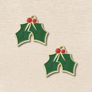 May include: Two holly leaf charms with gold-toned metal edges. Each charm features two dark green enamel leaves and two small red enamel berries at the top, with a small circular loop for attachment at the very peak of the design.