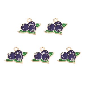 May include: Five gold-toned metal charms, each featuring a cluster of three dark blue blueberries with green leaves. The blueberries have white accents, and the leaves are outlined in green. Each charm has a small loop at the top for attaching to jewelry.