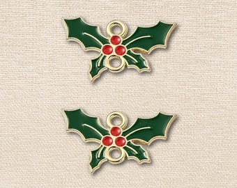 May include: Two identical holly leaf charms featuring dark green enamel leaves and three bright red enamel berries. Each charm is crafted from gold-toned metal with a smooth finish and includes two small circular loops for attachment purposes.