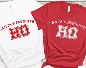 May include: Two t-shirts, one white and one red, each with the text "SANTA'S FAVORITE HO" in a collegiate style font. The phrase "BOTH DESIGNS INCLUDED" is printed on a red banner. The bottom of the image includes file type options.