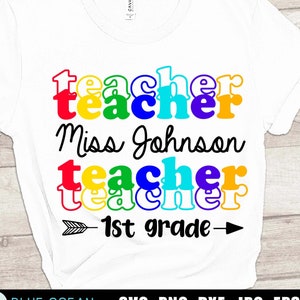 May include: A white t-shirt with the text "teacher" in rainbow colors, followed by "Miss Johnson" in black cursive, then "teacher" in rainbow colors again, and finally "1st grade" with an arrow on either side.