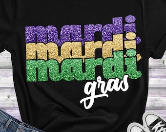 May include: A black t-shirt with a glittery design that says "Mardi Gras" in green, gold, and purple.