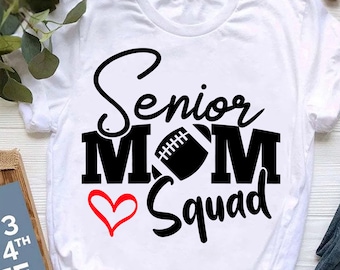 May include: White t-shirt with black text that reads "Senior Mom Squad" with a football and a red heart.