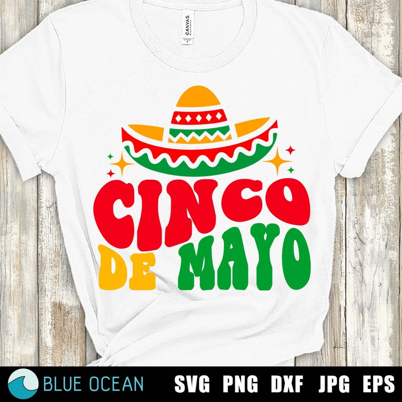 May include: White t-shirt with a colorful graphic of a sombrero and the text "Cinco de Mayo" in a retro font.