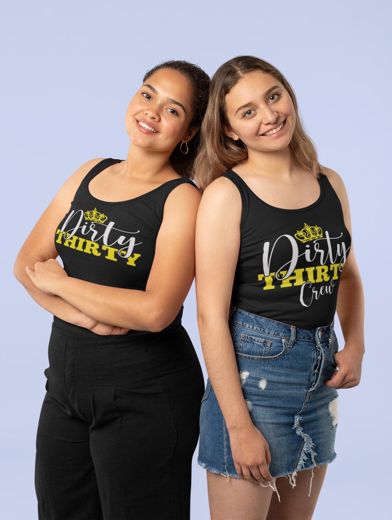May include: Two women wearing black tank tops with the text "Dirty Thirty" and a crown graphic. One tank top says "Dirty Thirty" and the other says "Dirty Thirty Crew".